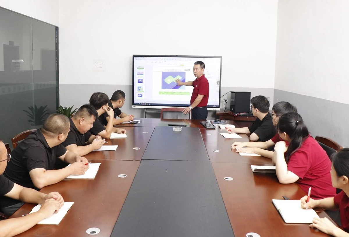 HM Manufacturing engineering team reviewing a part design in the meeting room