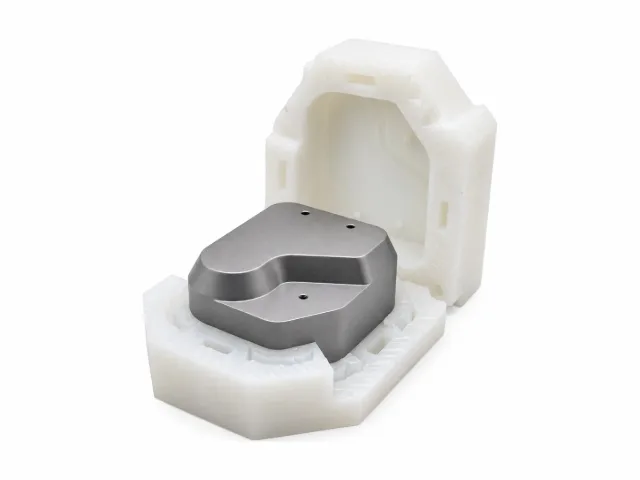 Rapid prototype part with a white plastic body and a machined metal insert